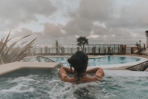 Woman looking out to sea from hot tub.