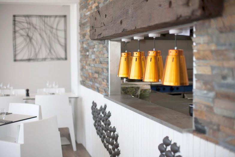 Chef's pass with copper lamps.