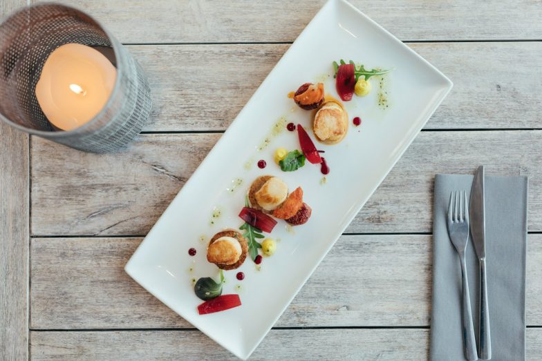 Rectangular plate of scallops from above.