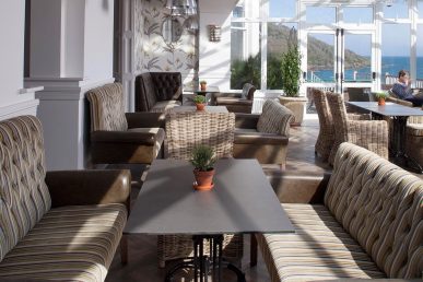 Conservatory with tables and chairs.