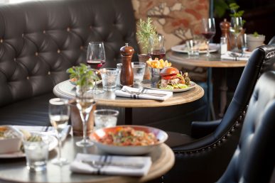 Restaurant tables with food and wine.