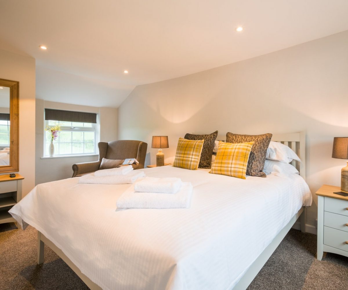 Large bed in warmly lit room.