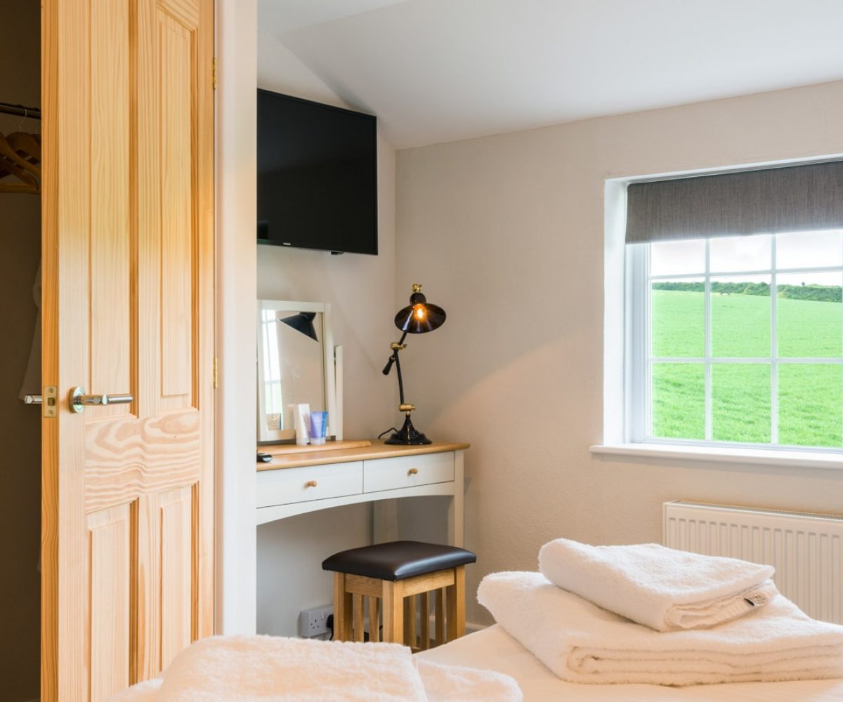 Small room with desk and view of fields.