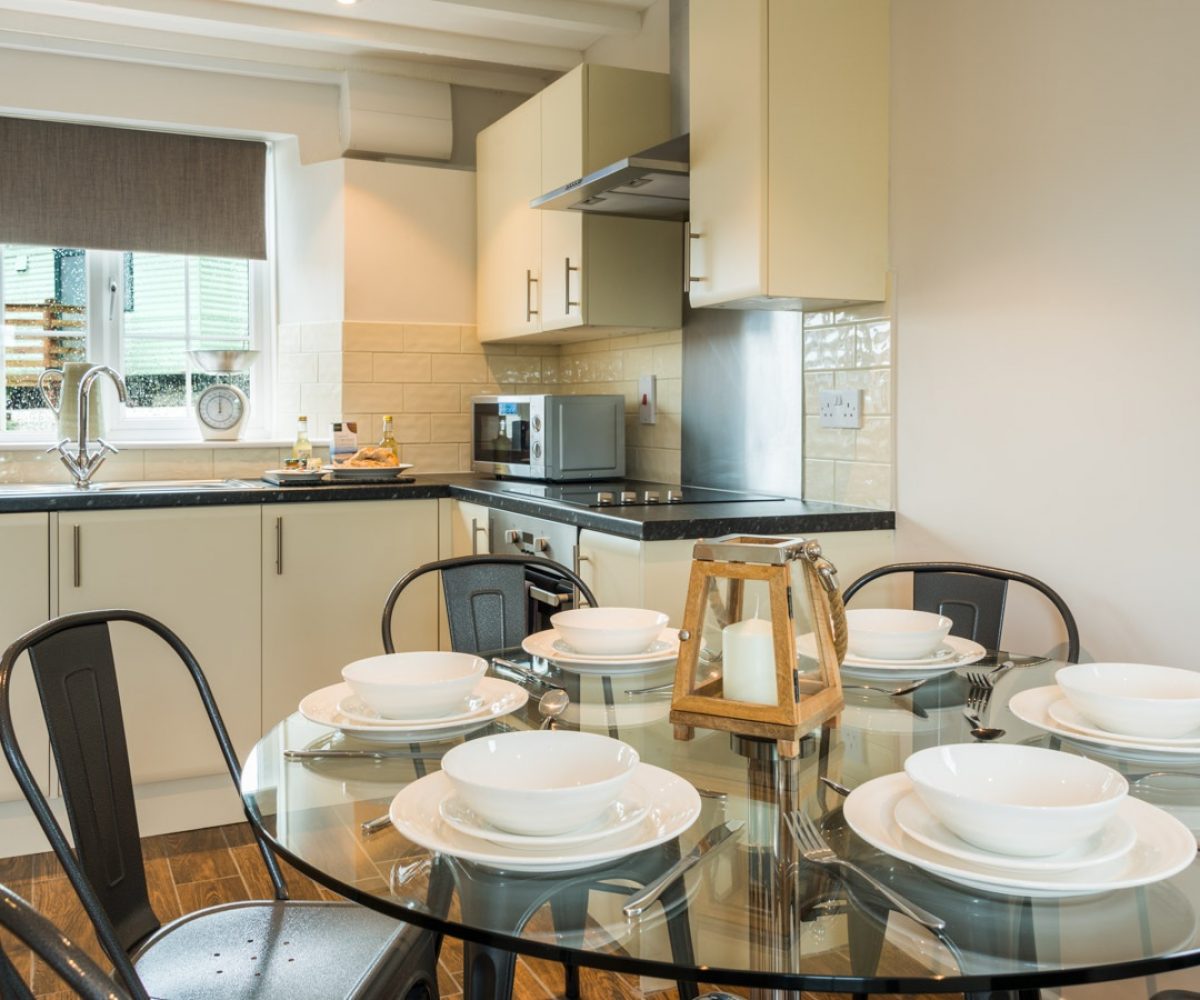 Round breakfast table in kitchen area.