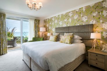 Double bed in room with double glass doors.