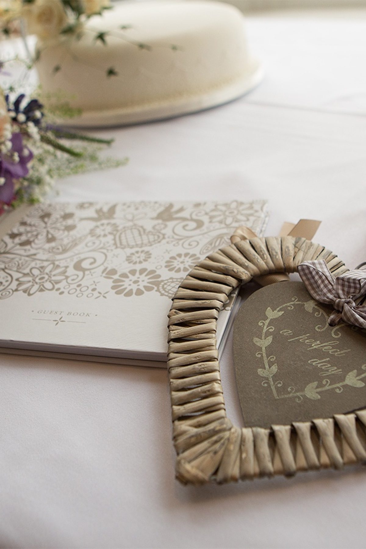 Wooden horse shoe and heart laid on table with white cloth.